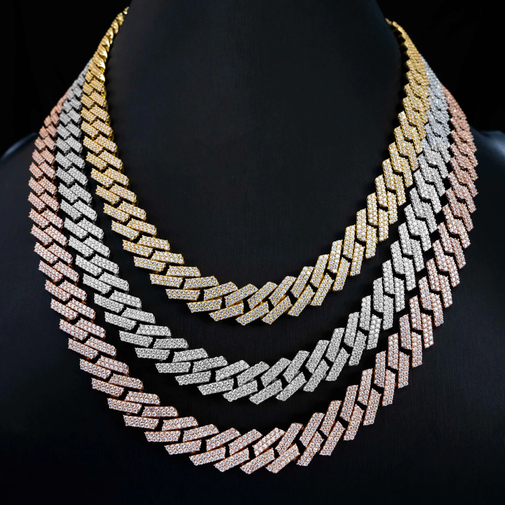Three-tone display of 10mm VVS moissanite Cuban chains in white gold, yellow gold, and rose gold on mannequin
