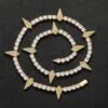 Gold panther tennis chain coiled on a black background showing iced out shine