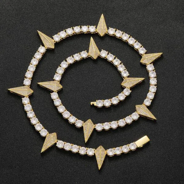 Gold panther tennis chain coiled on a black background showing iced out shine