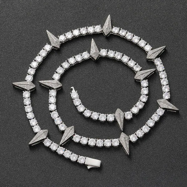 Silver panther tennis chain coiled on a black background showing iced out shine