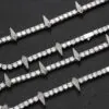 Four silver panther tennis chains laid flat on a table with clasp open for detail view