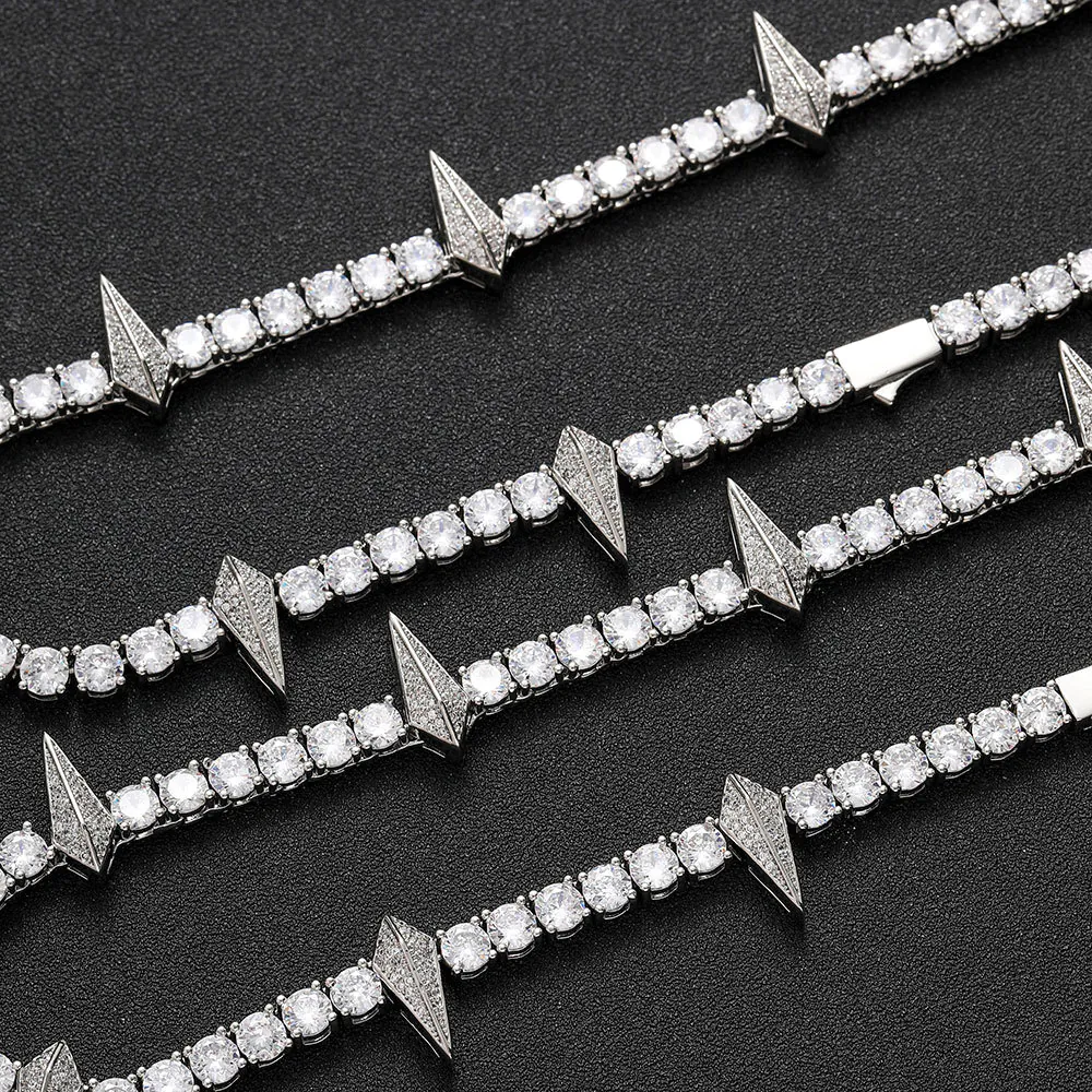 Four silver panther tennis chains laid flat on a table with clasp open for detail view