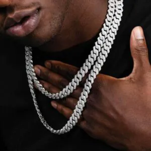 Two silver 14mm Cuban chains of different lengths displayed on a Black model’s neck