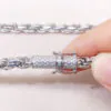 Close-up of white gold iced moissanite lock on 6mm rope chain