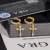 Yellow gold iced cross hoop earrings front view on GRA background