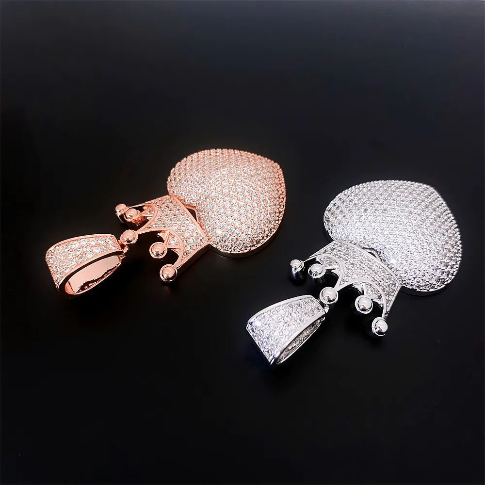 close up of curved heart pendant showing smooth surface and flat paved cz setting