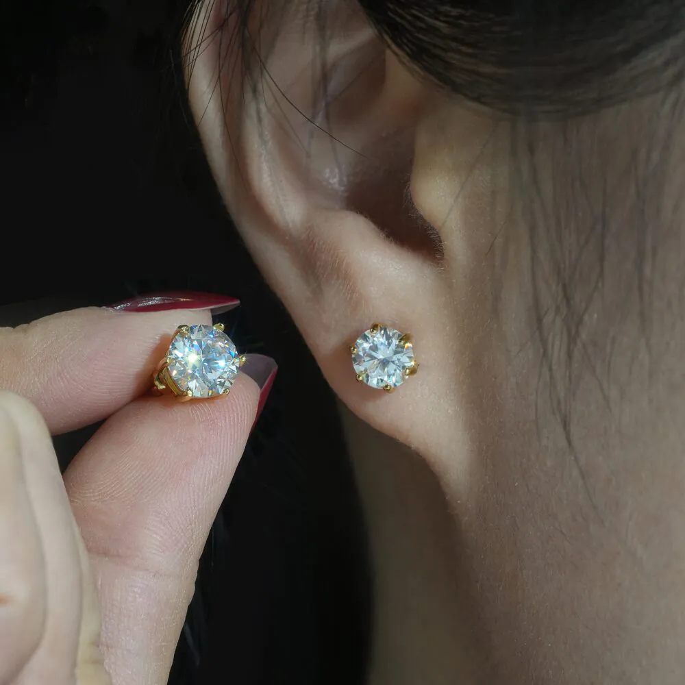 Model wearing six-prong solitaire moissanite stud earrings